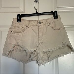 Distressed denim shorts in Ecru